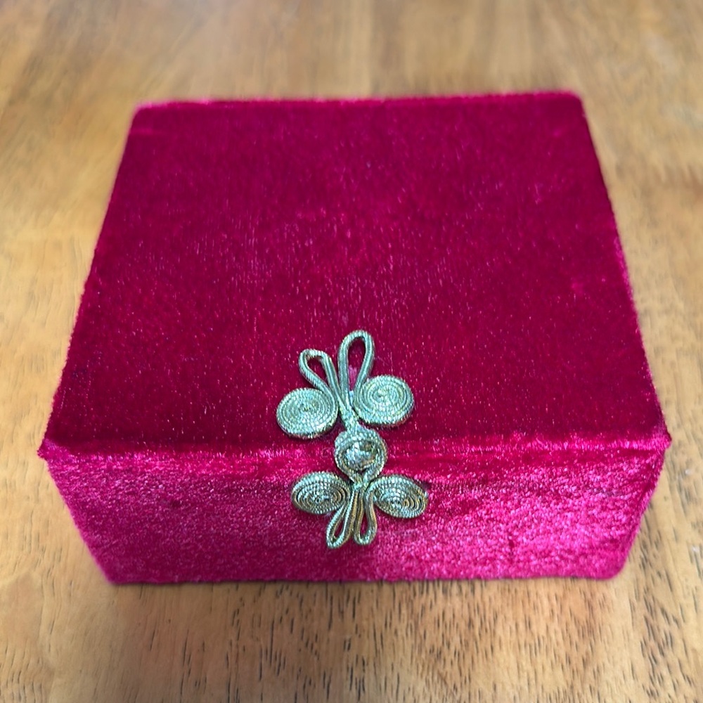 Pier 1 imports red velvet box with gold ribbon latch. Inside is red satin.